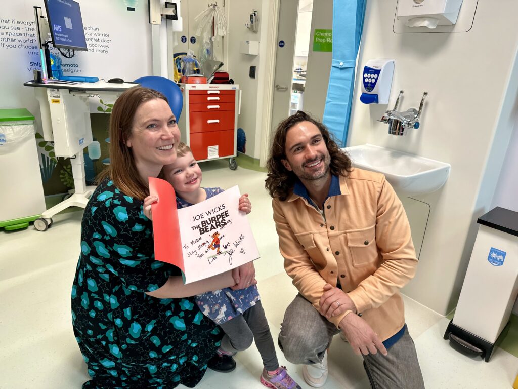 Joe Wicks gifting his book to patient